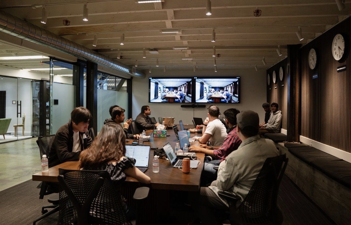 Conference room with dual screens and world clocks